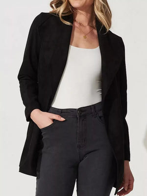 Black suede duster coat with open front and tie waist, worn over a white tank and jeans.