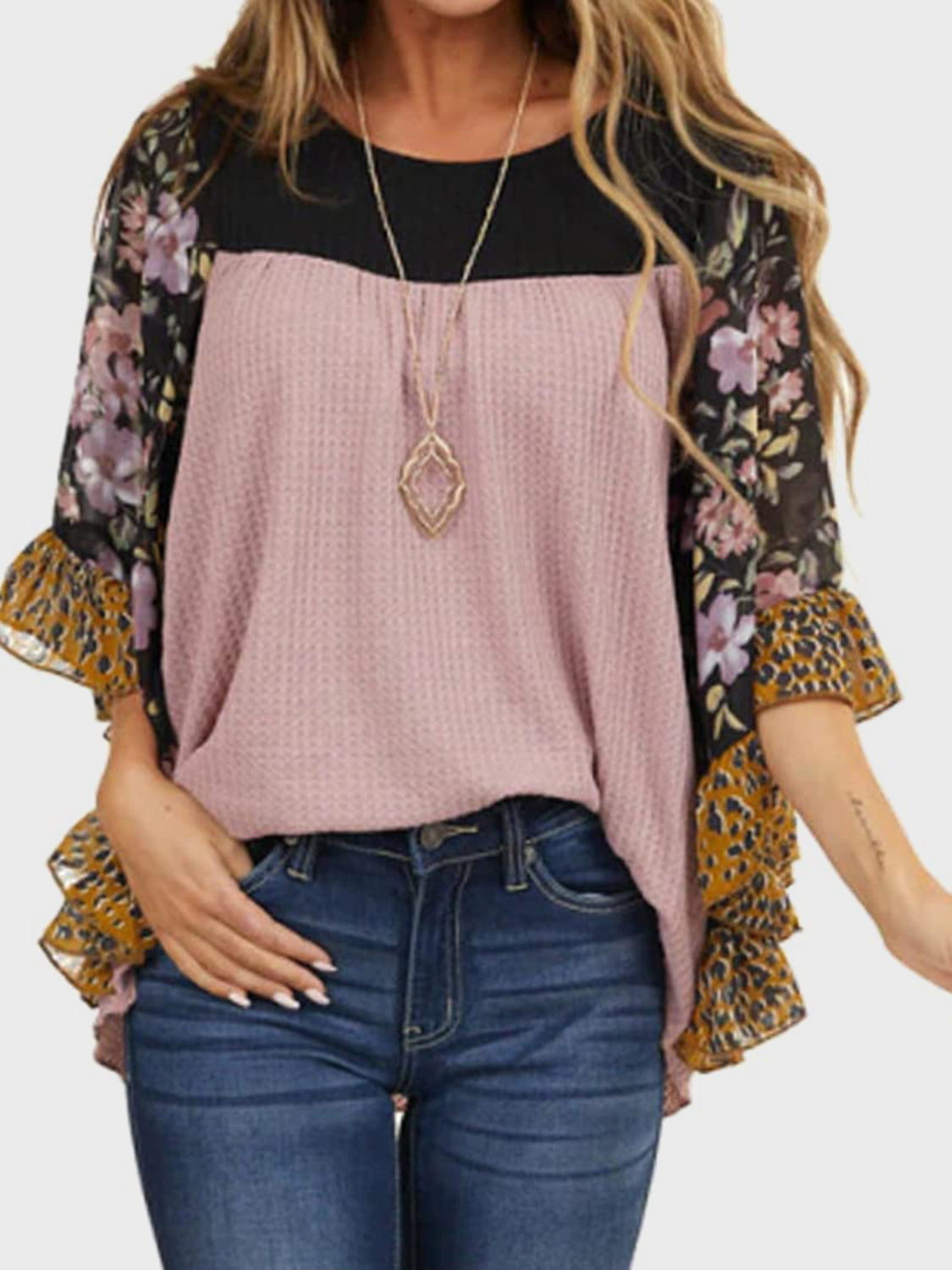 Mauve waffle knit blouse with black yoke and floral print flutter sleeves.
