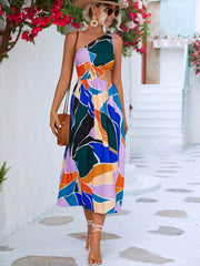 Abstract cutout midi dress with one shoulder and colorful geometric print.