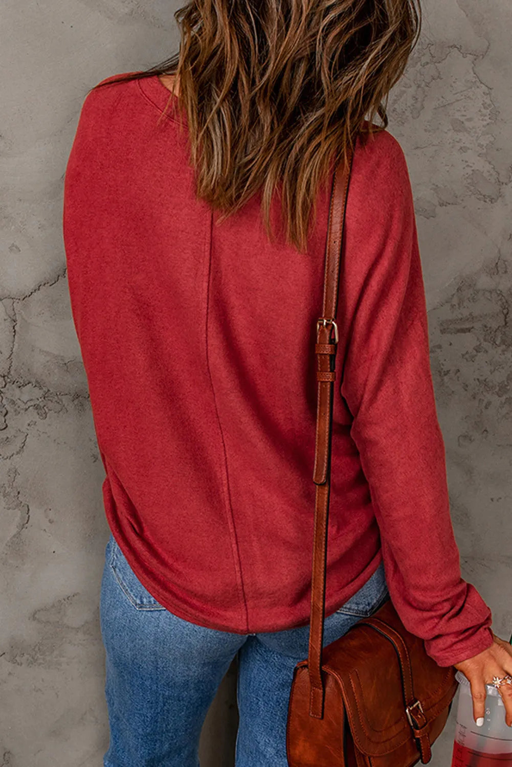 Scarlet crew neck sweater with embellished sleeves and a curved hem.