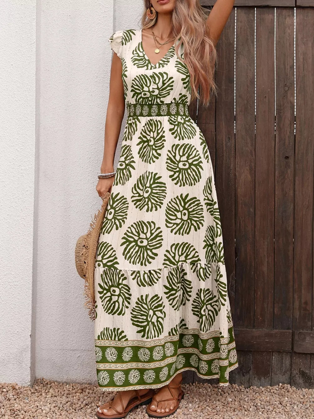 Botanical print V-neck maxi dress in cream with green botanical pattern, cap sleeves, and border print hem.