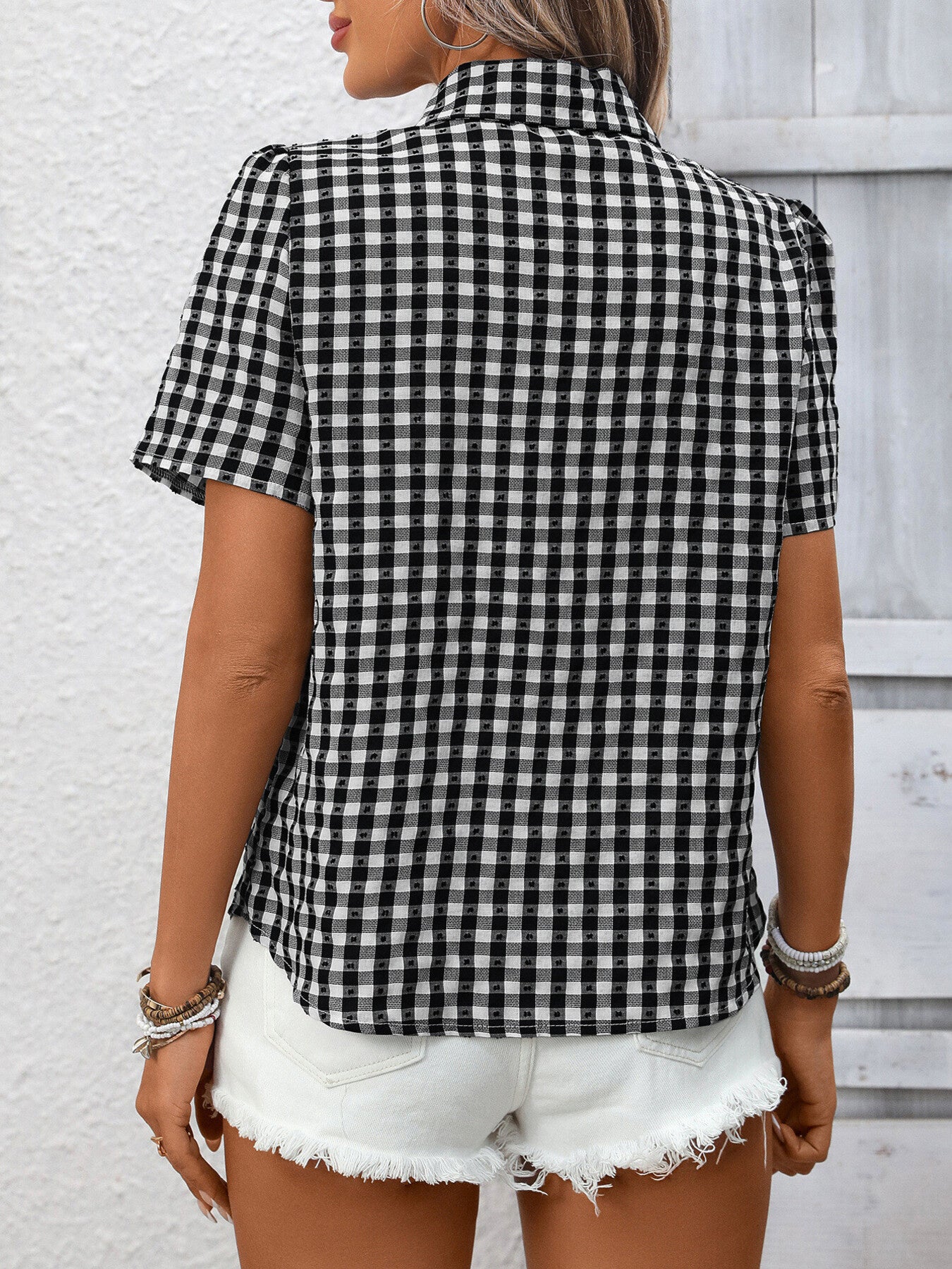 Black gingham button-up short-sleeve shirt with puff sleeves.