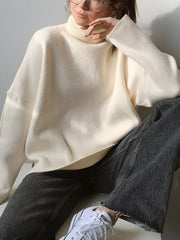 Ivory relaxed fit turtleneck sweater with sculptural sleeves and ribbed cuffs.