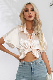 Ivory satin cuffed sleeve button-down blouse tied at waist