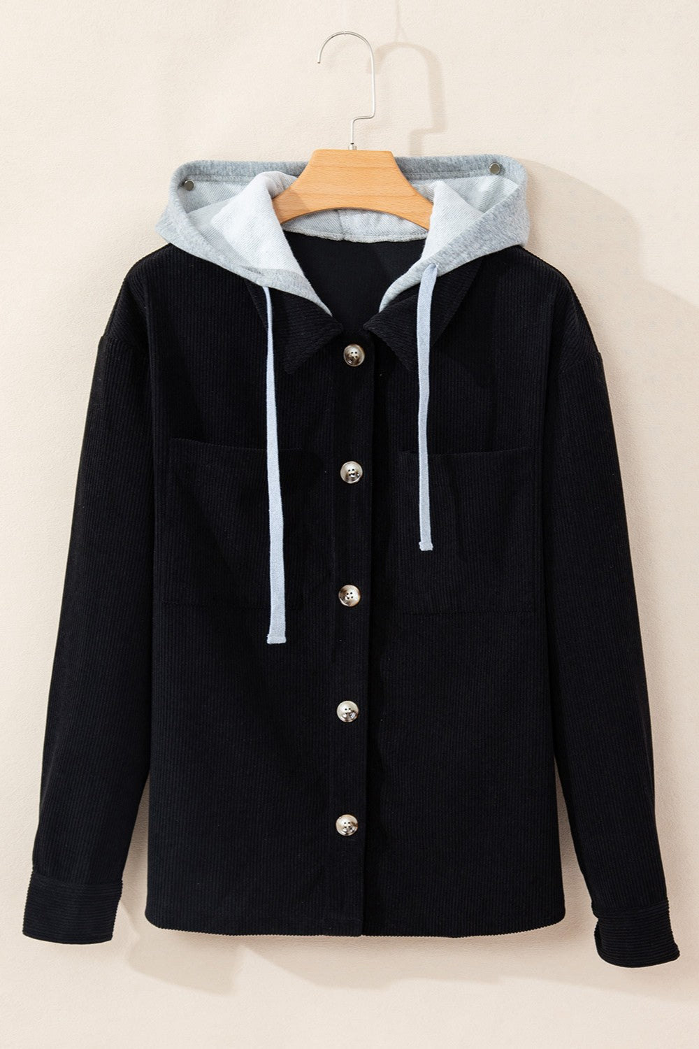 Black corduroy shirt jacket with contrast gray hood and light blue drawstrings.