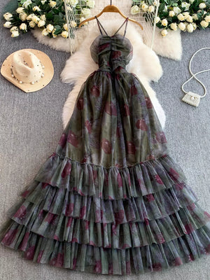Romantic floral mesh maxi dress with tiered ruffles and ruched bodice.