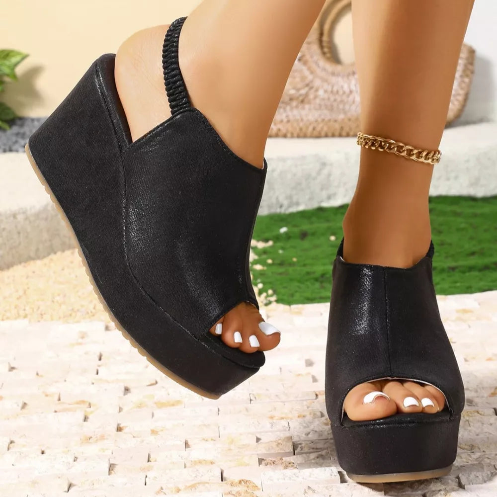 Black high heel wedge sandals with peep toe and elastic slingback strap.
