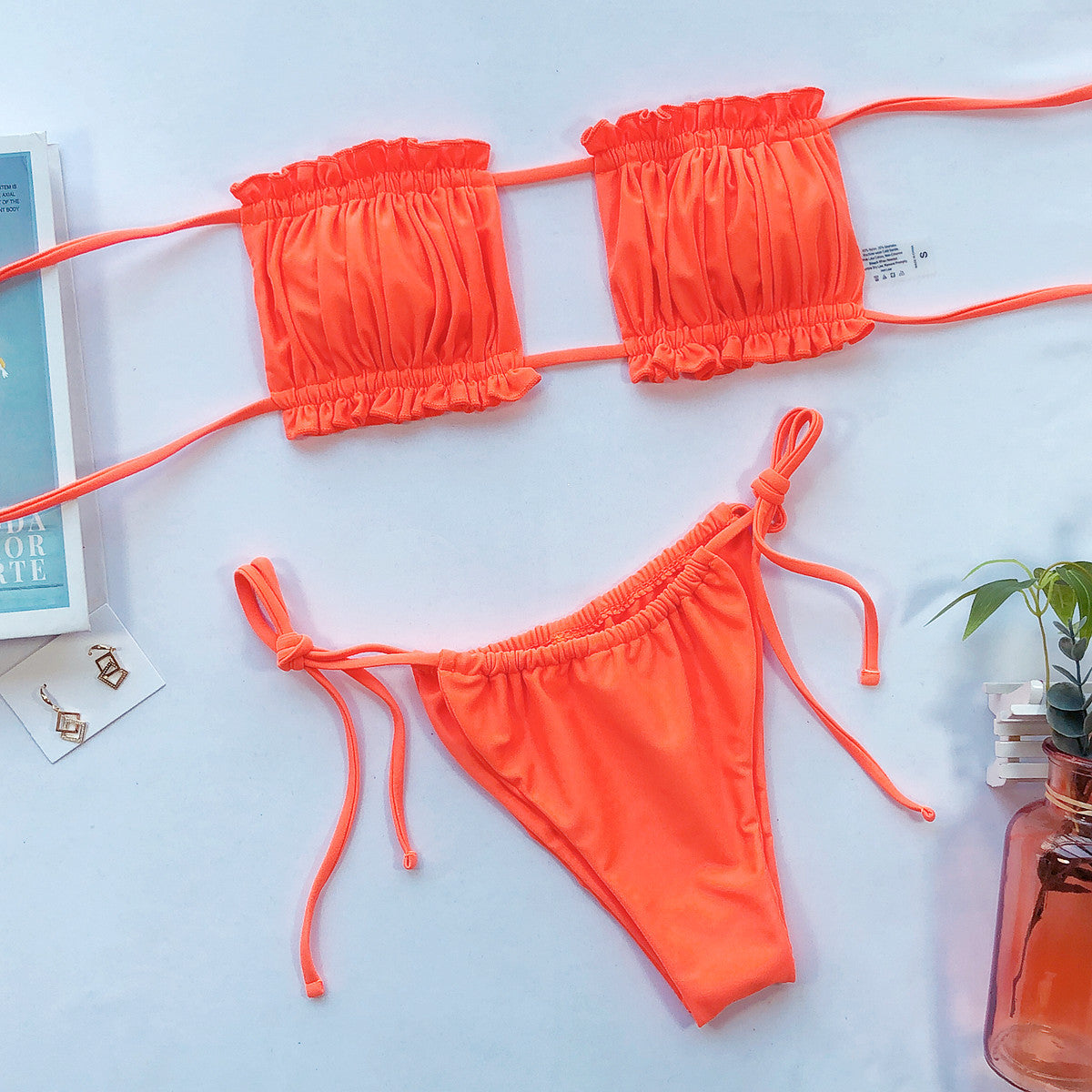 Orange bandeau bikini set with ruffled trim and tie sides.