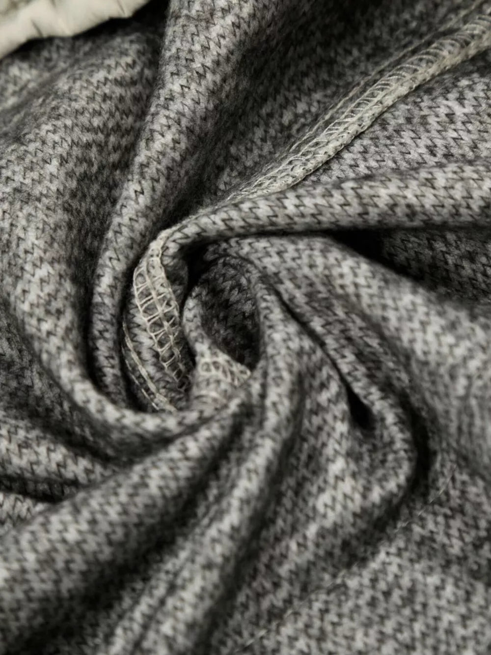 Gray men's sweatpants with a subtle chevron pattern and visible stitching detail.