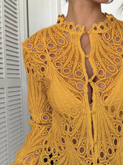 Yellow lace button-up blouse with scalloped collar and intricate cut-out details.