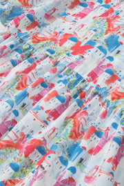 Watercolor village print peplum blouse with tiered ruffle detail in multicolor.