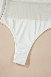 White mesh panel bodysuit with a thong bottom and opaque fabric detail.