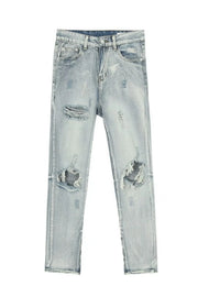 Distressed knee-slit light wash denim trousers with ripped details.