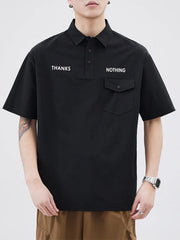 Black short sleeve polo with button detail and chest pocket, featuring white text.