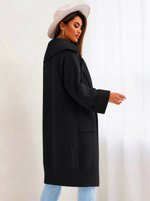 Black oversized knit lapel cardigan with pockets and cuffed sleeves.