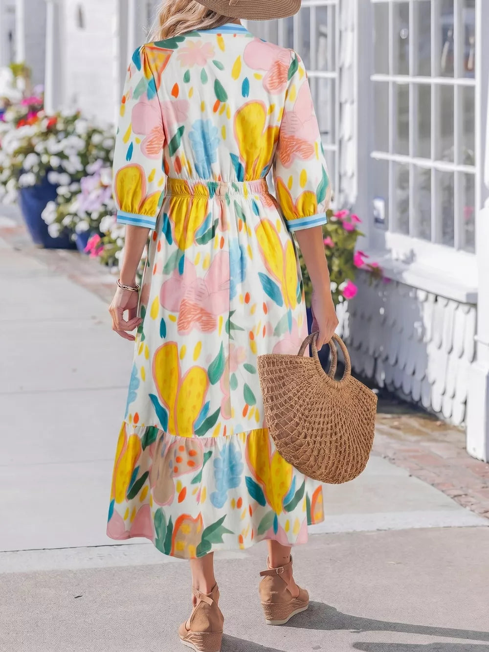 Midi dress with 3/4 sleeves and a whimsical floral doodle print in yellow, pink, and blue on white cotton.