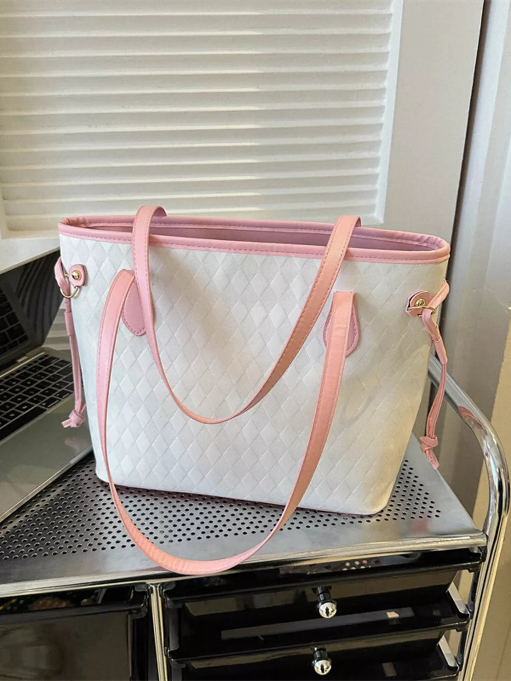 Textured diamond woven tote bag with pink trim and handles