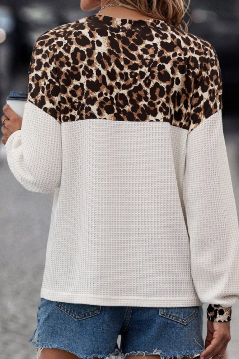 Leopard block henley waffle knit sweater in white with long sleeves and a relaxed fit.