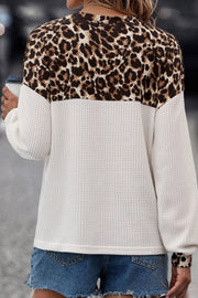 Leopard block henley waffle knit sweater in white with long sleeves and a relaxed fit.