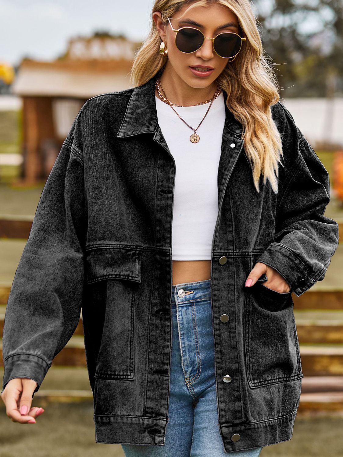 Oversized dark gray denim trucker jacket with collared neck and chest pockets.