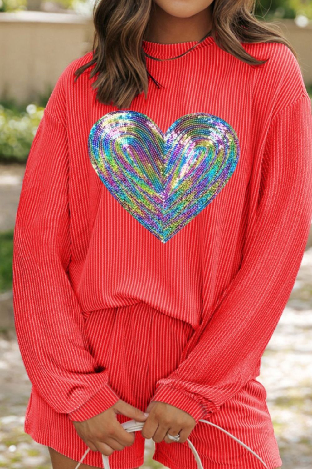 Orange-red ribbed lounge set with a sequin heart graphic on the top.