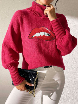 Pink turtleneck sweater with sequin lip graphic and balloon sleeves.
