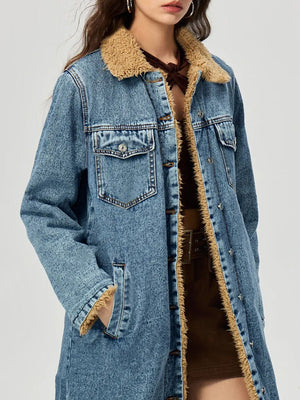 Denim maxi coat in medium wash with shearling trim and button closure.
