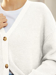 White ribbed knit button cardigan with V-neck and balloon sleeves.