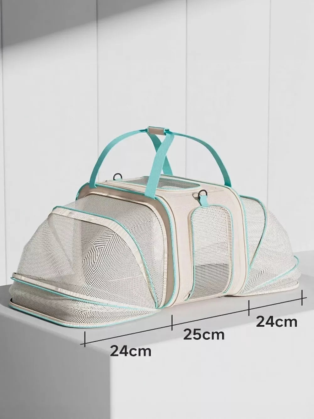 Beige and teal mesh pet carrier backpack with top handles and clear front panel.