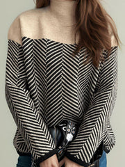 Chevron knit turtleneck sweater with colorblock tan and black chevron pattern.
