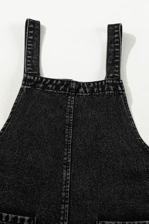 Black denim culotte overalls with distressed details and adjustable straps.