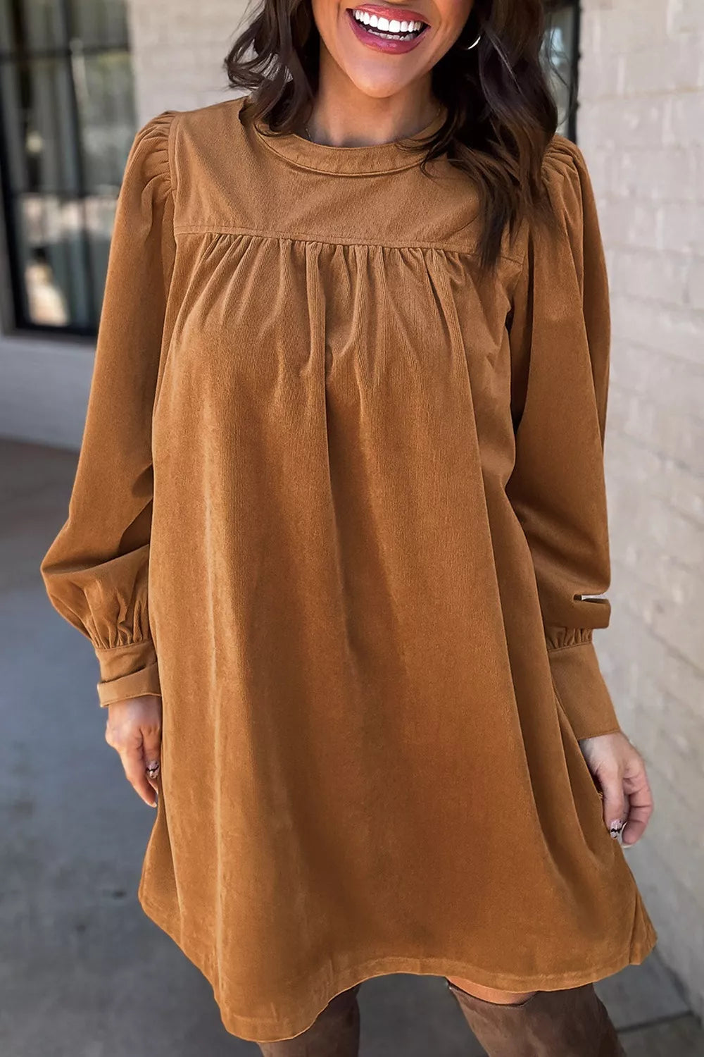 Caramel corduroy mini dress with puff sleeves and buttoned cuffs.