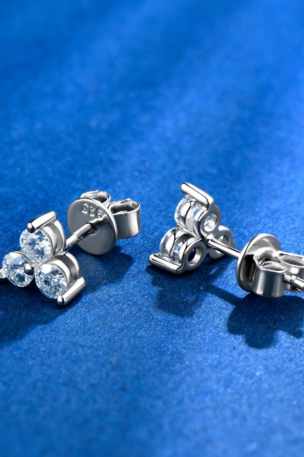 Silver Trilogy Moissanite Studs earrings with 925 sterling silver backs.