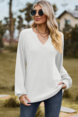 White waffle knit raglan V-neck top with eyelet detail on sleeves.