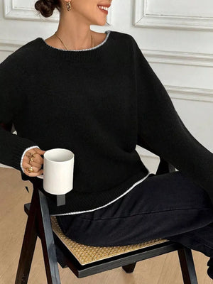 Black knit sweater with contrast trim and bowknot back detail