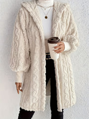 Beige hooded cocoon coat with textured cable knit, 100% polyester, open front, long sleeves.