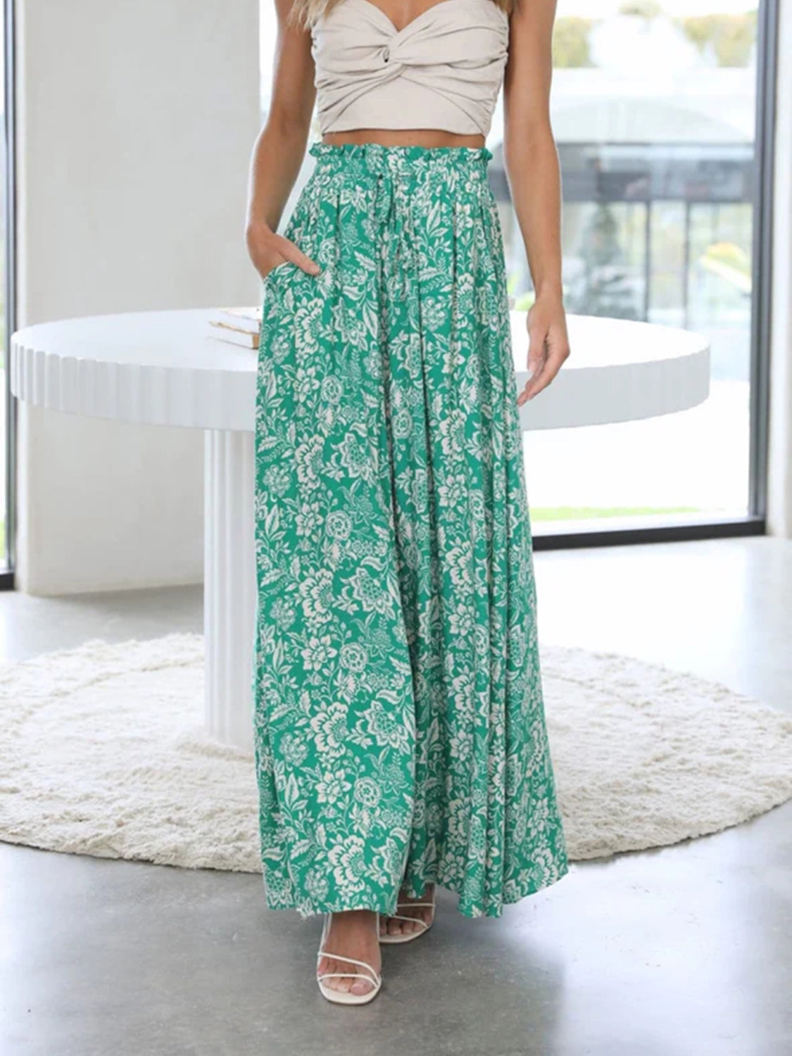 Green palazzo trousers with white floral print and ruffled waist.