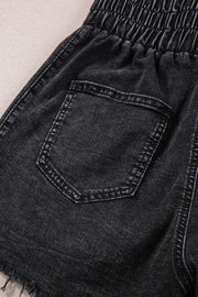 Black denim shorts with elastic waist and frayed hem detail