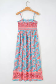 Bohemian floral maxi dress with smocked pink bodice and blue floral skirt.