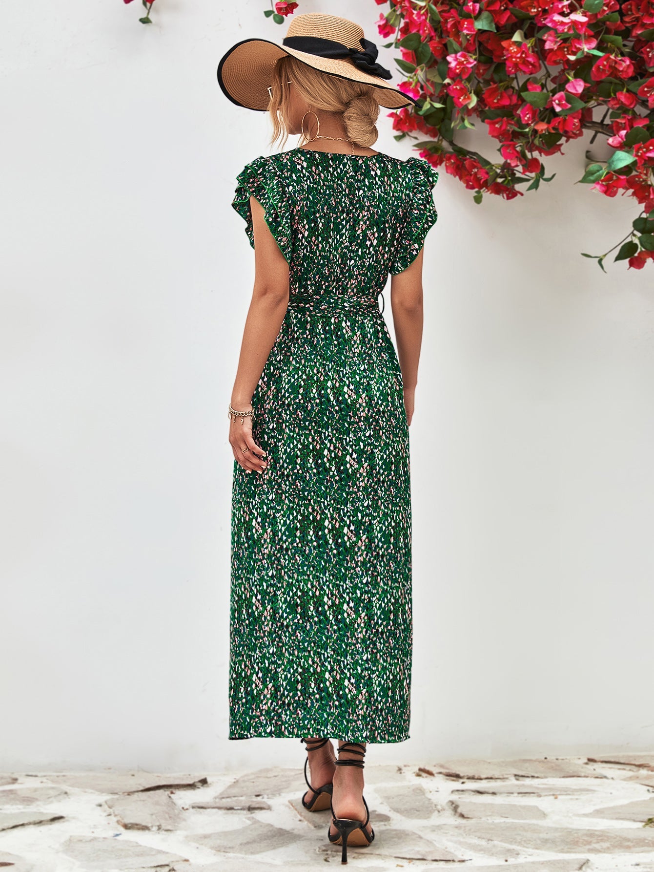 Green floral wrap midi dress with flutter sleeves and belted waist.