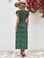 Green floral wrap midi dress with flutter sleeves and belted waist.