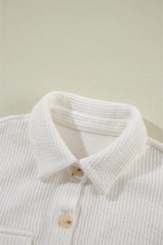 White textured corduroy overshirt with button front and patch pocket detail.