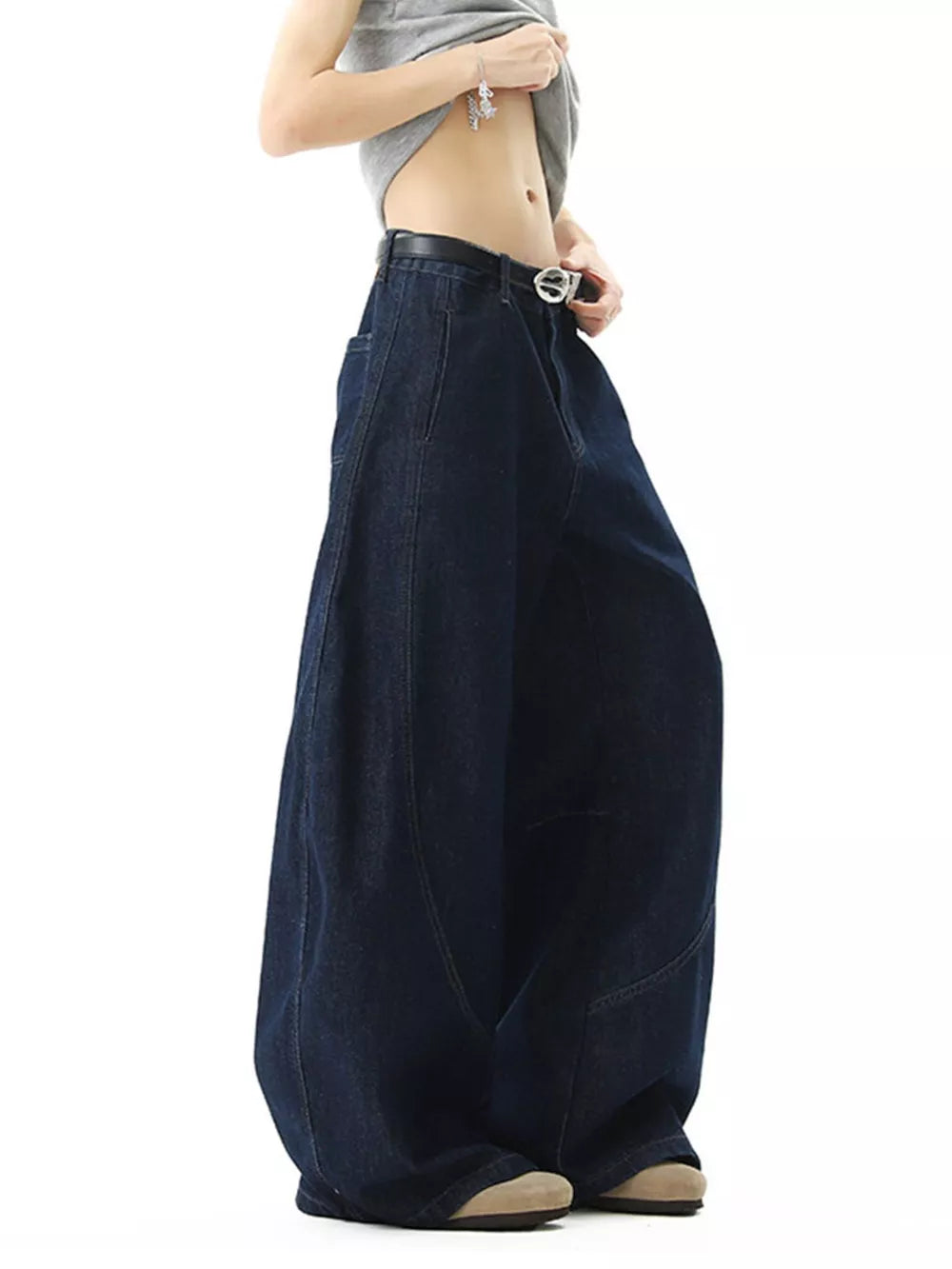 Men's dark wash cotton jeans with oversized wide legs and pockets.