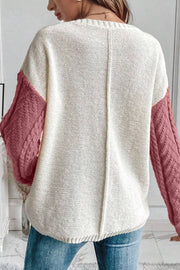Textured panel pocket sweater in cream with dusty pink cable knit sleeves.