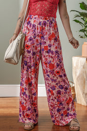Painterly floral palazzo trousers in strawberry pink with wide legs and an elastic waistband.