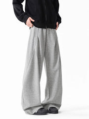 Men's gray wide-leg drawstring pants with a relaxed fit and subtle pleating.