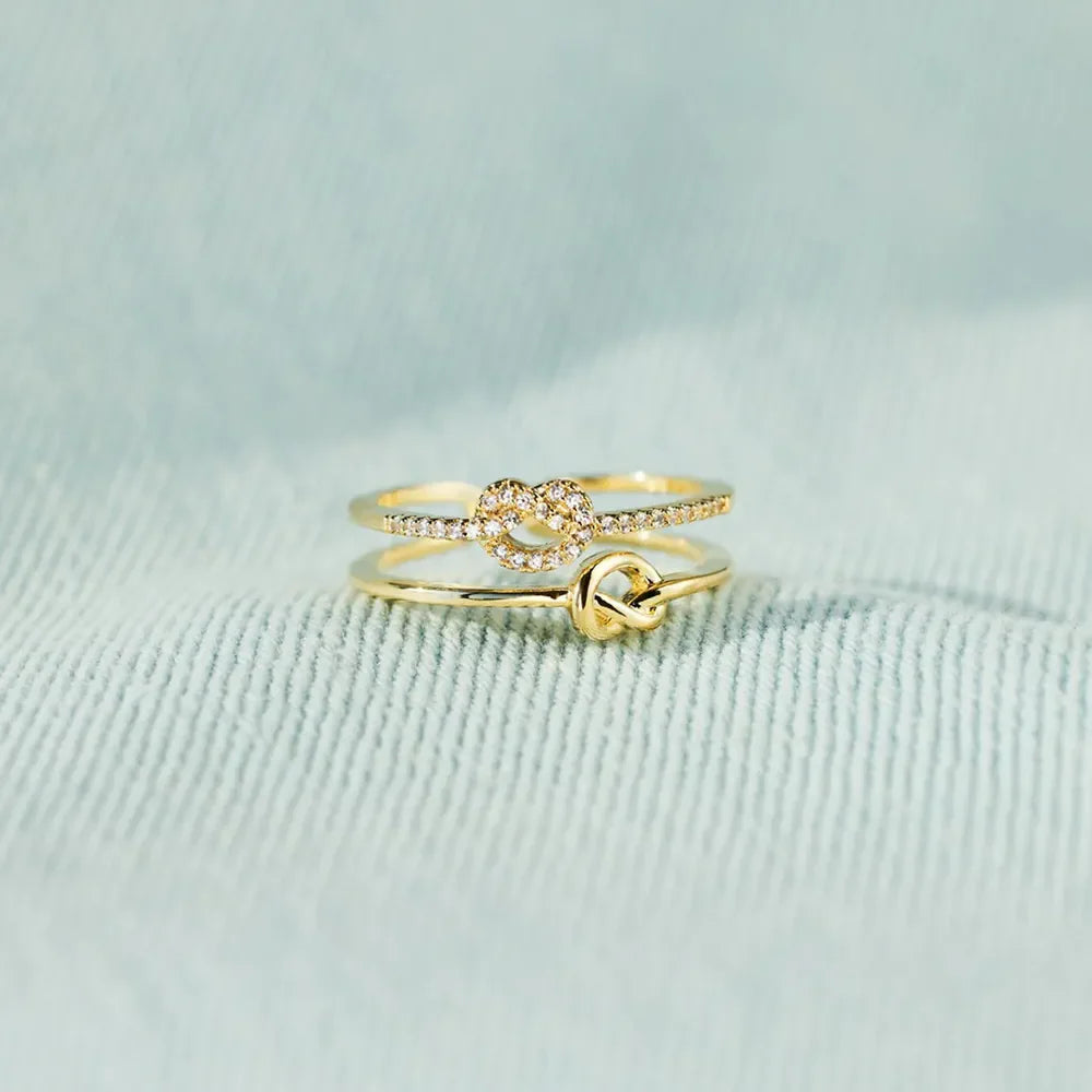 Gold knot rings, one with pavé detail, 18K gold-plated set