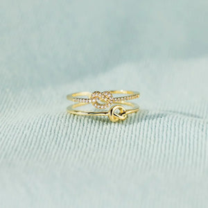 Gold knot rings, one with pavé detail, 18K gold-plated set