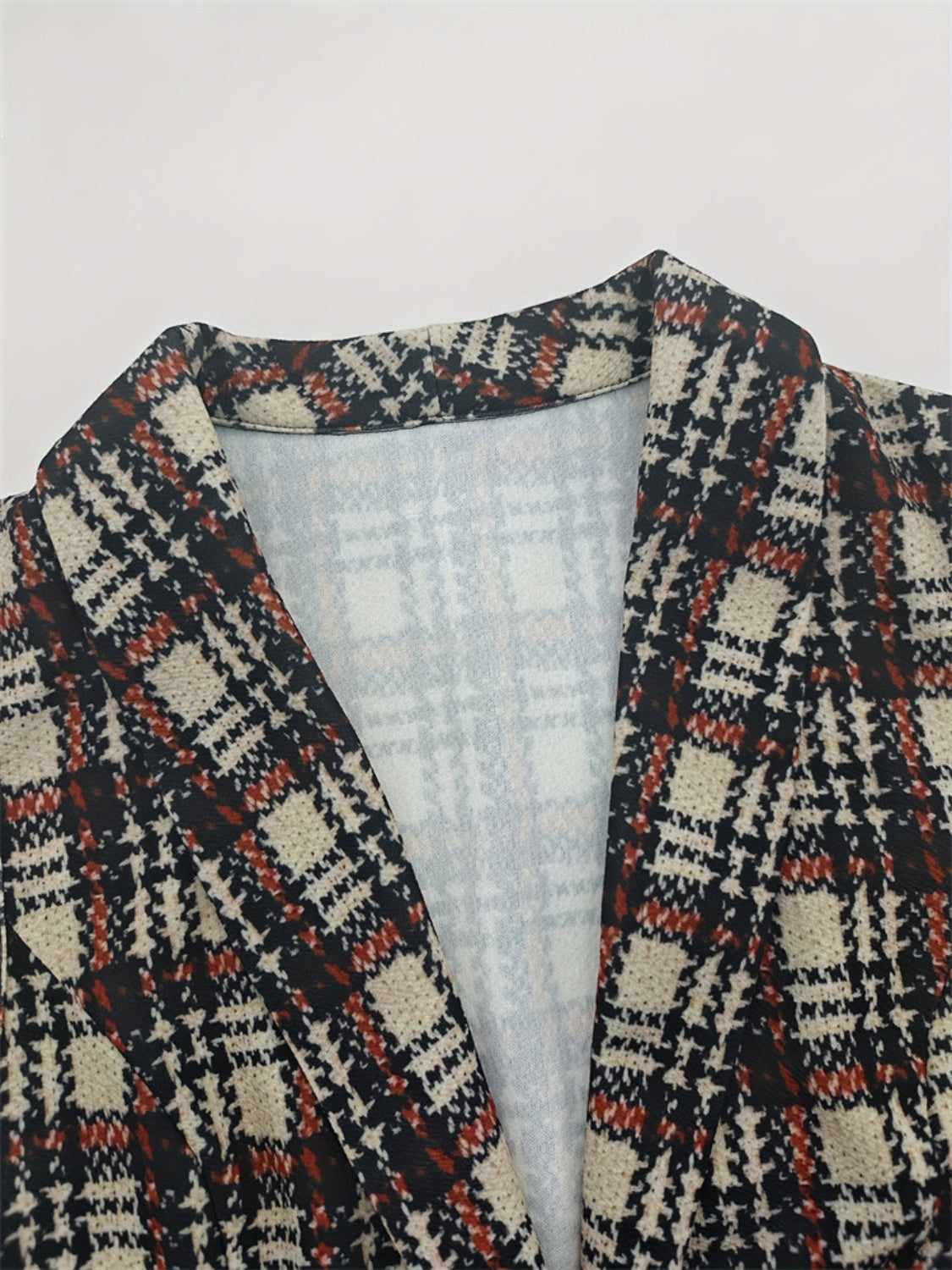 Tailored plaid vest with notch lapel and button detail