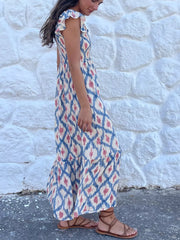 Smocked ruffle sleeve maxi dress with blue and pink ikat print and tiered skirt.
